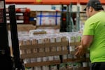 FILE - Food banks in Washington state are bracing for increasing demand as roughly 170,000 residents stand to lose food stamp benefits under the president's tax cut law. In this provided image, an Oregon Food Bank worker loads food at the warehouse in Northeast Portland in 2024.