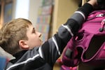 Class of 2025 student Johnathan grabs his backpack.