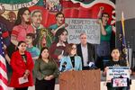 Service Employees International Union Local 503 regional director Nancy Flores Lopez, Innovation Law Lab’s Isa Peña, U.S. Rep. Andrea Salinas and U.S. Rep. Jeff Merkley speak to reporters in Woodburn, Ore., on Feb. 13, 2026. The mural above them reads “respect and fair wages for agricultural workers” in Spanish.