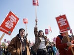 Marchers raise picket signs during a "Fight Starbucks' Union Busting" rally held in Seattle in April.