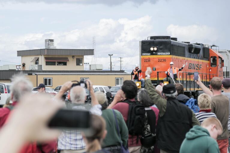 The train blared its horn, to which protesters responded with loud yells. One protester even brought their car to the tracks and started honking the horn.