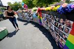 A visitor looks over a display with the photos and names of the 49 victims that died at the Pulse nightclub memorial Friday, June 11, 2021, in Orlando, Fla. Saturday will mark the fifth anniversary of the mass shooting at the site.