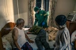 Paramedic Igshaan Adriaanse checks on a patient suspected to have taken a drug overdose.