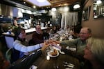 FILE: This Sept. 27, 2013, photo shows diners toasting at Naomi Pomeroy's Beast restaurant in Portland, Oregon, where guests enjoyed a six-course prix fixe meal based on bold flavors and the chef's penchant for butchering whole animals. 