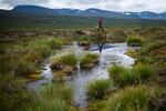 Scientist Keith Larson walks past a pond formed by thawing permafrost in Sweden.