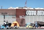 People walk by tents