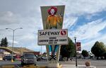 A safeway sign in Lakeview Oregon, with a cowboy with a gun on it