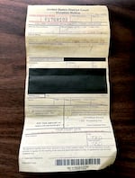 A criminal citation on a table in a photo provided by Holly Brown, a protester who was detained outside Portland's U.S. Immigration and Customs Enforcement office. Brown was detained on Oct. 4, 2025. But in this ticket, officers wrongly wrote she was arrested a month later. The ticket also gave her no information — aside from "TBD" — about when she needed to show up to court.