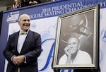 Dick Button smiles next to a painting of him while honored at the U.S. Figure Skating Championships in San Jose, Calif., Thursday, Jan. 4, 2018.