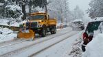 A snow plow works on clearing State Street in downtown Hood River, Ore., Dec. 17.