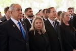 Israel's Prime Minister Benjamin Netanyahu, from left, his wife Sara Netanyahu, President Isaac Herzog and First Lady Michal Herzog, attend a ceremony marking the Hebrew calendar anniversary of the Hamas attack on October 7 last year, at the Mount Herzl military cemetery in Jerusalem, Israel Sunday Oct. 27, 2024.