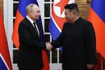 In this pool photograph distributed by the Russian state agency Sputnik, North Korea's leader, Kim Jong Un (right), and Russian President Vladimir Putin shake hands after a welcoming ceremony at Kim Il Sung Square in Pyongyang, North Korea, on June 19.