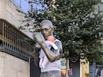 A statue of boxer Ken Buchanan in Edinburgh, Scotland. Buchanan is adorned with a baby doll wrapped around him as part of a campaign to raise awareness about paternity leave.