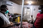 MAIDUGURI, BORNO STATE, NIGERIA - 2021/11/25: Medics from Médecins Sans Frontières stand over a pile of therapeutic food Plumpy'Nut, which is meant to treat malnourishment in Maiduguri, the capital of Borno State. Islamic militant group Boko Haram, and more recently a faction called ISWAP, have been waging an insurgency in northeast Nigeria for more than a decade.