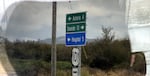 A highway sign on a rainy day