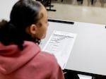 Students examine sample ballots in Reading High School where Chief Deputy Clerk Abe Dane educates students on the election process at Reading High School on Oct. 4, 2024 in Hillsdale, Mich.