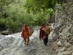 Two women from the village of Machulo farm their lands. As night falls, they'll steal water from a nearby stream that belongs to other residents.