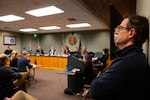 Mark Jamnik listens as Councilor Anthony Broadman describes the UGB expansion as a "down payment" on Bend's future at a city council meeting on Dec., 4, 2024. Jamnik shakes his head in disapproval at times.