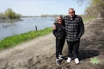 Grayson residents Lilia Lomeli-Gil and John Mataka stand next to a restored floodplain at the edge of town, providing a new open space for the community.
