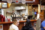 Restaurant co-owner Liz Mitchell works behind the bar at the Carver Hangar in Boring, Ore., on Jan. 6, 2021.