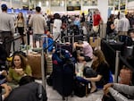 Passengers line up at London's Gatwick Airport amid a global IT outage on Friday.