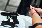 An attendee holds a Glock Ges.m.b.H. GLOCK 19 Gen5 9mm pistol during the National Rifle Association (NRA) Annual Meeting at the George R. Brown Convention Center, in Houston, Texas on May 28, 2022.
