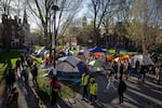 FILE - Students protesting against the war in Gaza, and passersby walking through Harvard Yard, are seen at an encampment at Harvard University in Cambridge, Mass., on April 25, 2024. Colleges’ financial ties with foreign sources have long been a concern among Republicans, and became a priority during Trump’s first term. It reemerged last week as the White House grasped for leverage in its escalating battle with Harvard University.