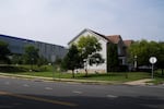A long Vantage data center building stands behind residential buildings in Sterling, Virginia.