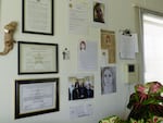 Kari Lee has decorated the wall above her desk with images and clippings related to the unidentified woman.