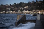Water spills over a set of stairs that typically lead to the beach during a King Tide at Alki Beach Park on Tuesday, December 5, 2017, in West Seattle.