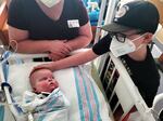 Bennett Markow looks to his big brother, Eli (right), during a family visit at UC Davis Children's Hospital in Sacramento. Bennett was born four months early, in November 2020.