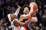 Portland Trail Blazers forward Deni Avdija, right, drives to the basket against Dallas Mavericks guard Brandon Williams, left, during the second half of an NBA basketball game Monday Dec. 29, 2025, in Portland, Ore.