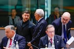 Ukraine's President Volodymyr Zelenskyy, second left, speaks with European Council President Antonio Costa, center rear, during a round table meeting at the EU Summit in Brussels, Thursday, Dec. 18, 2025.