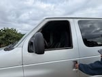 The driver's side window of a van is broken after ICE agents arrested four farmworkers on their way to work on Aug. 7, 2025, according to attorneys. Farmworker advocates say the arrest is the largest immigration enforcement action in the area this year.