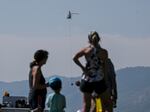 Onlookers watch while crews work near the Ken Caryl Ranch development as the Quarry fire burns Thursday, Aug. 1, 2024, southwest of Littleton, Colo.