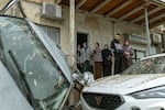 Arab-Israeli residents surveys the damage following a projectile strike in the Arab-Israeli city of Kfar Qassem on March 26, 2026.
