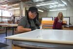 Melanie Baca helps produce window inserts at the Portland company Indow on March 16, 2020. Most employees started working from home during the coronavirus pandemic, but the factory workers can't do that.