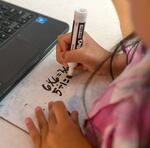 Amaris Molina, 8, solves math problems during class at Fern Hill Elementary School in Forest Grove, Ore., Nov. 9, 2023.