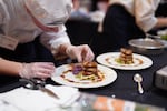 Crook County student Tayah Hagensee puts the finishing touches on their entrée for the Oregon ProStart Championship March 13, 2023. Crook County High School won first place in the culinary competition which challenged the students to prepare a three-course meal in under an hour, using just two butane burners.