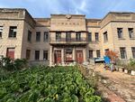 Vegetables grow in front of an abandoned movie theater in Yimianpo, in China’s northeastern Heilongjiang Province.