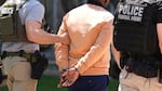 Federal agents take someone into custody after an immigration court hearing outside immigration court on May 21, 2025, in Phoenix.