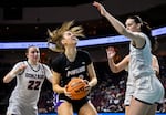 Portland forward Lucy Cochrane, center, looks to shoot against Gonzaga guard Brynna Maxwell (22) and Gonzaga forward Maud Huijbens during the second half of an NCAA college basketball game in the finals of the West Coast Conference women's tournament Tuesday, March 7, 2023, in Las Vegas.