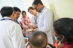 Oregon Health & Science University opthalmologist Beth Edmunds, back row, second from right, helps screen patients at Chittagong Eye Infirmary and Training Complex in Chittagong, Bangladesh, Nov. 24, 2024. Edmunds traveled to the country to teach local doctors a minimally invasive operation for adults and children with glaucoma.