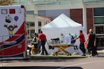 In this April 9, 2020, file photo, healthcare workers wheeling a gurney into Salem Hospital's emergency room in Salem, Ore., during the coronavirus outbreak. A new, larger wave of coronavirus outbreaks across Oregon has many areas that were relatively spared from the spring surge struggling to keep up this fall. 