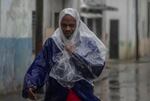 A man walks through the wind and rain brought by Hurricane Rafael in Havana, Cuba, Wednesday, Nov. 6, 2024.