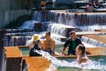 The cool water in the Ira Keller Fountain Park in downtown Portland shown in this June 28, 2021, file photo may be calling this week as temperatures are expected to reach into the 80s and possibly the 90s. 