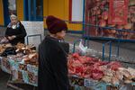 Lilia Lymanska (right) sells home-cured meats at her market stall in Dobropillya, Ukraine, on Oct. 17. Lymanska lives in nearby Pokrovsk, a coal mining center that is very close to the front line and is under frequent Russian artillery barrages and aerial attacks. She says it is impossible to sell her goods there and it has become increasingly dangerous. Dobropillya is also frequently coming under attack by Russian missiles, drones and rockets.