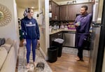 Shelby Boyd, left, who now uses a cane or walker for support, talks with her husband, James Daniel Boyd III, at their home in Lake Oswego, Aug. 11, 2022. Boyd, who had COVID-19 in January 2021, still suffers from long COVID-19 symptoms, but is trying to work again.
