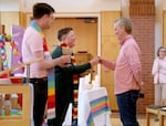 Rev. Melinda Holloway, center, gives communion to Dan Woodward at First United Methodist Church in Portland, Ore., on May 8, 2024. The church was celebrating the removal of anti-gay language from the United Methodist Church rulebook.