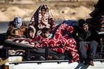 Syrian Kurds fleeing areas north of Aleppo arrive in Tabaqah, on the western outskirts of Raqa, on December 3, 2024.
